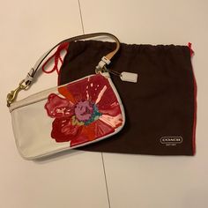 Coach White Leather Handbag With Beautiful, Colorful Flower. Comes With Original Protective Bag. Never Used. Designer Bags With Zipper Pouch For Gifts, Designer Bags With Zipper Pouch As Gift, Designer White Shoulder Bag Clutch, White Clutch Pouch With Dust Bag, Coach Multicolor Clutch Bag, Multicolor Coach Clutch Bag, Coach Bags With Removable Pouch As Gift, Designer White Pouch Clutch, Coach Rectangular Zipper Pouch