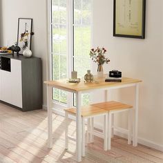 a kitchen table with two stools next to it