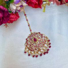 Featuring a large edwardian era inspired jadau maang teeka in 22k gold plateds sterling silver,set with precious freshwater pearls and synthetic stones that resemble rubies. The beads in hangings are real rubies and pearls. The teeka weighs 16gms and the chain length is 8.5cms with a hook at the top All our Gold Plated Jewellery is made using 925 Silver as the base metal. The beads in hanging and strings (like in our 22k gold jewelry) are always precious freshwater pearls and high quality ruby, Temple Jewelry Tikka For Eid Celebration, Temple Jewelry Style Tikka For Eid Celebration, Eid Celebration Temple Jewelry Tikka, Temple Jewelry Tikka With Intricate Design As Gift, Intricate Design Tikka For Diwali Gift, Yellow Gold Temple Jewelry Tikka For Festive Occasions, Festive Yellow Gold Tikka With Tilla, Festive Yellow Gold Tilla Tikka, Elegant Cutdana Tikka As A Gift