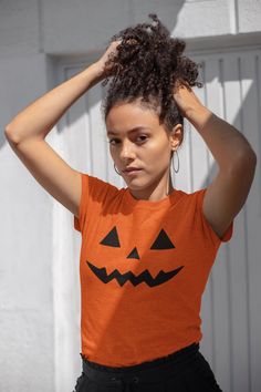 A spooky and fun Pumpkin face design on this T-Shirt is perfect for Halloween enthusiasts and anyone who loves festive attire. This comfortable and durable tee can be worn year-round for casual or semi-formal occasions. Product features - Shoulder tape for stability - Tubular knit for seamless construction - Ribbed knit collar for elasticity - Made from strong and smooth fabric - Classic fit and tear-away label for comfort Care instructions - Machine wash: warm (max 40C or 105F) - Non-chlorine: bleach as needed - Tumble dry: medium - Do not iron - Do not dryclean Pumpkin Face Designs, Festive Attire, Spooky Costumes, Fun Pumpkins, Pumpkin Face, Costume Shirts, Pumpkin Faces, Face Design, Fall Festival