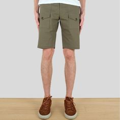 Crafted from Japanese cotton ripstop fabric, our Olive Expedition Shorts are the go-to for comfort and utility. With a zipper fly and corozo nut button closure, you'll enjoy a secure fit, plus the added bonus of two front patch pockets and two rear patch pockets for convenience and storage. Ready to accompany any excursion. 98% Cotton, 2% ElastaneMade in Canada Khaki Cotton Cargo Pants With Patch Pockets, Military Cotton Bottoms With Cargo Pockets, Military Cotton Cargo Bottoms, Military Style Khaki Cotton Cargo Pants, Military Style Cotton Cargo Pants With Patch Pockets, Military Cargo Style Short Pants, Short Cotton Bottoms With Patch Pockets, Utility Cargo Pants With Welt Pockets For Outdoor, Military Cotton Bottoms With Side Pockets