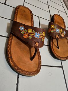 Brown leather floral flip flops made in Mexico. Adorable floral pattern with thick, soft leather interior. US Women's size 8 Bohemian Leather Summer Flip Flops, Handmade Bohemian Brown Flip Flops, Bohemian Brown Flat Flip Flops, Bohemian Brown Leather Lace-up Sandals, Leather Flip Flops Womens, Brown Leather Flip Flops With Buckle Closure, Hippie Sandals, Floral Flip Flops, Floral Sandals