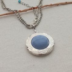 "Photo necklace for women.  Rounded silver plated picture locket with natural Blue lace agate cabochon.  Photo locket necklace. Vintage locket. Picture necklace gift   This necklace measures 25\" inches in length Fit 20 mm I include always a free surprise gift with every order All items are wrapped individually in a gift box Shipment arrives in 4 week by registered mail Contact me with any questions or requests, I'd be happy to help" Blue Oval Locket Necklace, Oval Blue Locket Necklace, Blue Round Locket Necklace, Blue Round Pendant Locket Jewelry, Blue Medallion Locket Necklace As Gift, Blue Medallion Locket Necklace, Blue Bohemian Jewelry With Locket, Blue Bohemian Locket Jewelry, Bohemian Blue Locket Jewelry