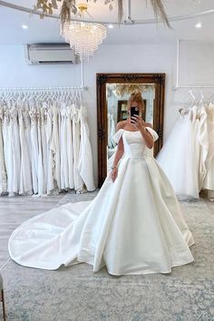 a woman in a wedding dress taking a selfie