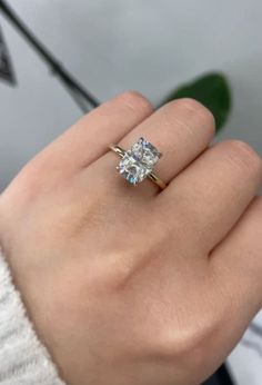 a woman's hand with a diamond ring on it