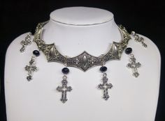 Victorian Gothic metal choker with hollow crosses and black crystal beads, ornate metal necklace, Victorian jewelry, Gothic jewelry A beautifully ornate gothic silver metal choker with Victorian hollow cross charms and black faceted crystal beads. It measures approx. 11 inches in length and has lobster clasp fastening and an extension chain, so that it can be adjusted to fit the neck. The choker is made up of 7 silver toned metal ancient style sections that have intricate detailing. A marvelous Gothic Metal Necklaces With Jewels, Silver Cross Jewelry For Halloween, Gothic Cross Pendant Jewelry For Halloween, Gothic Black Metal Cross Necklace, Gothic Cross Necklace For Festivals, Adjustable Gothic Cross Pendant Jewelry, Gothic Metal Necklace, Silver Gothic Jewelry For Jewelry Making, Halloween Silver Jewelry With Cross Pendant