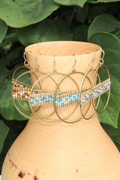 Add a vibrant touch to your outfit with these colorful beaded hoop earrings. Handmade with love, these hoops are crafted using golden brass and high quality seed beads in a delightful array of colors. The intricate beadwork adds a playful and eye-catching element to these earrings, making them a must-have for any jewelry lover. Lightweight and comfortable to wear, these hoops are perfect for adding a pop of color to your everyday style or dressing up for special occasions. They also make a wonde Beaded Brass Hoop Earrings For Gift, Brass Beaded Dangle Hoop Earrings, Brass Beaded Hoop Earrings As Gift, Gold Beaded Brass Hoop Earrings, Multicolor Beaded Brass Earrings, Multicolor Dangling Beaded Brass Earrings, Adjustable Hoop Beaded Earrings With Colorful Beads, Handmade Multicolor Metal Hoop Earrings, Beaded Metal Small Hoop Earrings