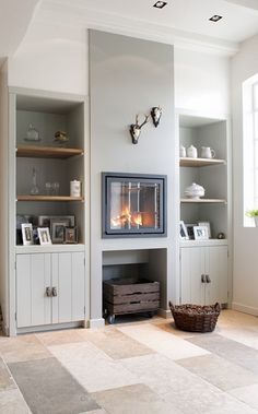 a living room filled with furniture and a fire place next to a wall mounted tv