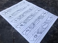 two sheets of paper with designs on them