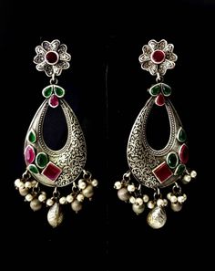 Stunning German silver Indian Chandbali earrings, embellished with sparkly cut CZ stones. Eye catching asymmetric design with a scrolling floral pattern on one half of the earring, and the CZ stones on the other half! Beautiful dangly pearls and silver color stamped balls move when you move, in a very alluring way! Pretty ear stud in shape of flower. Grey finish, polished to a lovely soft lustre. Lots of intricate detail! Excellent quality and craftsmanship! Length 3 3/4 in Width 2 in Weight 14 Silver Temple Jewelry Chandelier Earrings With Intricate Design, Silver Kundan Chandelier Earrings With Intricate Design, Silver Bollywood Jhumkas With Matching Earrings, Heavy Silver Round Chandelier Earrings, Silver Chandelier Earrings With Intricate Design For Festive Occasions, Silver Teardrop Chandelier Earrings With Latkans, Silver Chandbali Chandelier Earrings With Stone Work, Silver Kundan Chandelier Dangle Earrings, Silver Chandbali Temple Earrings