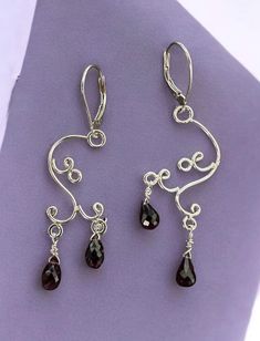 Elegant chandelier earrings crafted with stunning rhodolite garnet gemstones set in sterling silver. Lever back Elegant Garnet Teardrop Earrings, Elegant Garnet Earrings, Silver Gemstone Chandelier Drop Earrings, Silver Gemstone Drop Chandelier Earrings, Elegant Pierced Garnet Earrings, Elegant Silver Garnet Earrings, Elegant Nickel-free Garnet Earrings, Elegant Drop Garnet Jewelry, Elegant Sterling Silver Chandelier Earrings With Gemstones