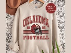 Show off your love and support for the Sooners with this unisex football crewneck ♥️🏈.  This trendy, retro style OK football sweatshirt is pure comfort and is sure to become your new favorite! ✨ FIT & STYLE ✨ This soft, cozy sweatshirt is a medium-heavy fabric. This runs true to size so size up for a more loose, oversized fit.  The collar is ribbed knit, so it retains its shape even after washing and there are no itchy side seams on these sweatshirts.  .: 50% cotton, 50% polyester .: Medium-hea Retro Sweatshirt For Game Day, Sports Season, Retro Sweatshirt For Game Day And Sports Season, Retro Sweatshirt For Game Day, Retro Fan Gear Sweatshirt For Sports Season, Retro Sweatshirt For Fall Sports Events, Retro Sweatshirt For Sports Events In Fall, Retro Fall Sweatshirt For Fan Gear, Retro Fan Gear Sweatshirt For Fall, Retro Fall Fan Gear Sweatshirt