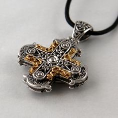 Our cross Sphere is influenced by Byzantine culture and therefore rich in ornaments. It is handmade in silver and 18 k gold, the dimensions are 3,0 cm in width, 3,0 cm in height. Height including the loop is 4,5 cm. Our pendants and crosses don't come with a chain. Luxury Crucifix Cross Necklace For Formal Occasions, Luxury Formal Cross Pendant Necklace, Luxury White Gold Cross Necklace, Luxury Cross Necklace For Formal Occasions, Luxury Formal Cross Necklace, Formal Spiritual Crucifix Jewelry, Luxury Cross Pendant Necklace, Luxury Sterling Silver Cross Necklace, Byzantine Cross Necklace With Engraving