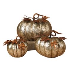 three metal pumpkins sitting on top of each other