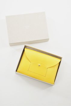 The lovely Ric Rac card case is made by folding a single piece of leather. Because it is made with a plant-based tanned cowhide the more you use it, the more it will become a unique luster and color. The main pocket is divided into two so you can store your business cards,credit cards and ID. You can also use it as a wallet for small amounts by inserting coins and placing folded banknotes. One pocket can hold up to 8 credit cards and 12 business cards (normal thickness), and can hold up to 16 ca Yellow Card Holder With Card Slots As Gift, Yellow Rectangular Card Holder Gift, Classic Yellow Rectangular Wallet, Fold Wallet, Belt Jewelry, Ric Rac, Pop Bottles, Shoe Gifts, Black Mini