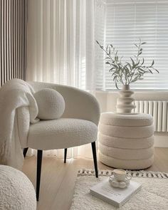 a white chair sitting in front of a window