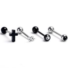 three pairs of black and silver piercings with cross design on each one earring