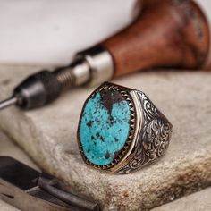 This striking men's silver ring features a large, natural turquoise stone, renowned not only for its vibrant color but also for its supposed healing properties. Turquoise is often believed to bring peace and protection to the wearer, promoting well-being and spiritual harmony. Handcrafted with meticulous attention to detail, this ring is a bold statement of style and the healing embrace of nature. * Discover our handmade Agate stone minimal ring in silver natural gemstone classic men accessory s Artisan Turquoise Ring With Polished Finish, Artisan Turquoise Ring With Polished Finish As Gift, Artisan Oval Ring With Patina, Artisan Oval Turquoise Ring With Polished Finish, University Symbol, Navajo Silver Jewelry, Large Turquoise Ring, Minimal Ring, Natural Turquoise Stone