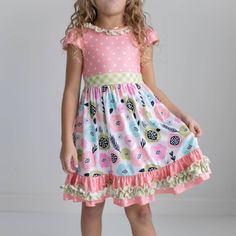 Peach, green, pink, blue floral print, polka dot, and gingham check print dress. Cap sleeve with keyhole back detail. Lots of ruffles for twirling! From premium brand Oopsie Daisy. Cute puff sleeves and full skirt make for perfect Easter spring photos! 95% Polyester, 5% spandex for all the comfort and just the right amount of stretch. Available in sizes 3y-12y. This dress Made in the USA and ships from our US warehouse, arriving to you within about 3-5 business days. Playful Spring Ruffle Dress With Ruffle Hem, Cute Spring Ruffle Dress For Garden Party, Pink Floral Print Ruffle Dress For Spring, Playful Ruffle Dress For Spring, Pink Ruffle Dress For Spring Garden Party, Playful Dresses With Ruffle Hem For Spring, Cute Fitted Ruffle Dress For Garden Party, Pink Short Sleeve Twirl Dress With Floral Print, Cute Polka Dot Dress With Ruffles