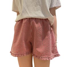 the back of a woman's shorts with red and white gingham checks