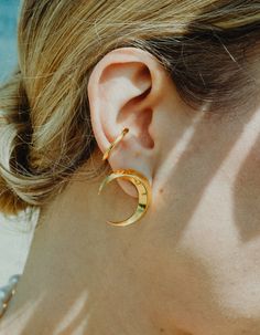 Symmetrical moon-shaped earrings made of sterling silver or sterling silver plated with 24 ct gold. Motif diameter: 24 mm. Decorative engraving on the reverse.We observe the phases of the Moon on Earth trying to solve the mystery of lunar attraction, but one side of this peculiar celestial body is always hidden in the shade of the Sun. Moon Phases Earrings, Everyday Crescent Single Earring, Single Gold-plated Round Ear Cuff, Minimalist Gold Crescent Cartilage Earrings, Gold Plated Moon Phase Jewelry, Pierced Silver Ear Cuff Gold Plated, Elegant Half Moon Brass Jewelry, Minimalist Half Moon Metal Jewelry, Celestial Gold-plated Single Earring