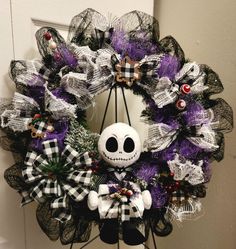 a halloween wreath with a skeleton on it