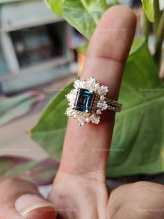 ✥ R I N G & M A T C H I N G ∙ B A N D ∙ B R I D A L ∙ S E T ✥ ♦ Main Stone: London Blue Topaz ♦ Size: 1.50 CT (8x6 mm) ♦ Cut: Emerald Cut ♦ Shape: Emerald ♦ Color: London Blue ♦ Ring & Band Metal: 10K Solid Gold ♦ Side Stone Cut: Tapered Baguette-Cut And Round Cut Moissanites ♦ Side Stone Total Weight:1.48CTTW Approx. ♦ Free Engraving ♦ Nickle Free ♦ Free Shipping to the United States ✥ O T H E R ∙ I N F O R M A T I O N ✥ ♦ Due to every item in our shop being made to order we are open for modera Baguette Cut Topaz Wedding Ring, Wedding Topaz Ring With Baguette Cut, Baguette Cut Topaz Ring For Wedding, Wedding Jewelry With Baguette Cut Blue Topaz, Gold Blue Topaz Ring With Halo Setting, Blue Topaz Baguette Cut Jewelry For Wedding, Blue Topaz Gemstone Cluster Ring For Wedding, Cluster Blue Topaz Jewelry For Anniversary, Blue Topaz Cluster Jewelry For Anniversary