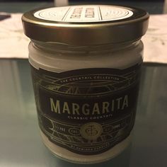 a jar of margarita sitting on top of a table