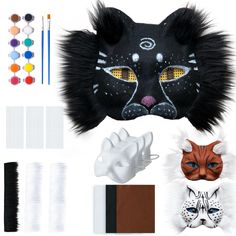 an assortment of animal masks and accessories including one cat mask, the other with eyes painted on it