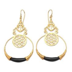 A tiny openwork circle hangs within a delicately crafted golden hoop in this exquisite pair of earrings from Made Nuada. Hand crafted from 18k gold-plated brass the earrings feature curling golden designs and a small but striking water buffalo horn accent at the bottom of the hoop. Golden Hoops, Golden Design, Water Buffalo, Henna Tattoo Designs, Balinese, Bead Earrings, Henna Tattoo, Beaded Earrings, Horn