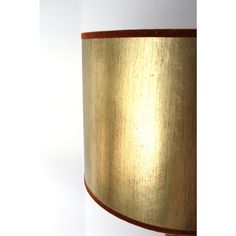 a lamp that is on top of a white wall with a brown trim around it