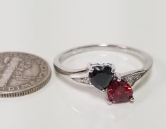 "Thanks for shopping our vintage estate store. We tend to sell well below wholesale and truly hope you enjoy all of our items. Many of the items are one of a kind, so please enjoy scrolling through the pictures and hopefully something will catch your eye. Black spots are from camera. Nice estate sterling silver 925 garnet or ruby with black cz diamond heart with by pass ring. This is a custom made ring from our shop, meaning we set the gems into the setting. Ring Size: please select a size Setti