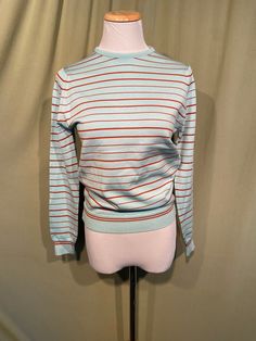 This is a sweet, vintage top from the 70s. Labeled, Touche' From Talbott.  Tagged a size 34. The bust measures 32" without stretching, see measurements below.   Made of blue & brick red nylon blend in a fine knit striped pattern. The top has a crew style neckline. It has long sleeves with ribbed cuffs & a ribbed band bottom hem. It has a good amount of stretch. Zips in the back with a nylon zipper. The top is in good condition!  No damage or wear. No soil or stains.  Classic!  Measurements were taken with the garment lying flat. If you have never worn vintage before, please measure yourself!! Vintage sizes run smaller than today's sizes, know your measurements before buying! Bust measured from side seam to side seam at the underarm: 16" unstretched for a 32" or slightly smaller or larger b Retro Fitted Long Sleeve Sweater, Vintage Long Sleeve Stretch Sweater, Retro Stretch Knit Sweater, Retro Knit Stretch Sweater, Retro Red Sweater For Spring, Retro Blue Knit Top, Red Retro Sweater For Spring, Retro Blue Tops For Fall, Blue Retro Tops For Fall