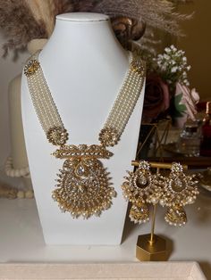 What a perfect way to mark Eid and add a touch of glamour! This elegant long Indian necklace comes with a set of polki earrings, making it the perfect addition to your wardrobe. The beautiful Indian jewelry style is ideal for making a statement at an Indian wedding. Enjoy the timeless classic look and feel Bollywood glamour wherever you go. Elegant Kundan Necklace For Eid Celebration, Elegant Bridal Necklace For Eid Festivities, Elegant Chandbali Kundan Necklace For Eid, Elegant Chandbali Necklaces For Eid, Festive Kundan Necklace With Pearl Drop For Celebrations, Elegant Kundan Necklace With Latkans For Diwali, Elegant Stone Work Necklace For Eid, Elegant Kundan Bridal Necklace For Eid, Eid Chandbali Elegant Necklaces