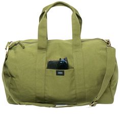 a green duffel bag with a cell phone in it's pocket and strap