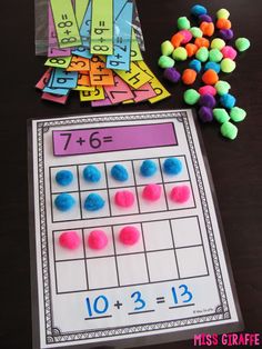 a table topped with lots of different colored candies next to a sheet of paper