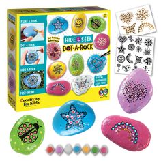 an assortment of rocks and stickers in a box with instructions to make them look like they are painted