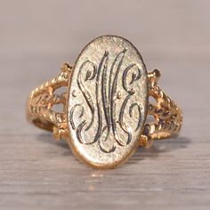 The Rouge: Vintage Signet Ring In Yellow Gold. This Elegant Ring Features An Elongated Oval Top Oriented North To South, Adorned With A Hand-Engraved Monogram At The Center, Which Can Be Customized With Your Initials For An Additional $250 Upon Request. Flanking The Center, Patterned Double Split Shanks Complete The Look, Adding Depth And Dimension To The Design. Crafted In 14 Karat Yellow Gold, The Ring Exudes Warmth And Sophistication. Currently Sized At 3, It Can Be Adjusted To Fit Any Finger Size Upon Request For An Additional Charge, Ensuring A Perfect And Comfortable Fit For The Wearer. Elongated Oval, Split Shank, Elegant Ring, Hand Engraving, Signet Ring, Gold Yellow, Womens Jewelry Rings, Gold Color, Initials