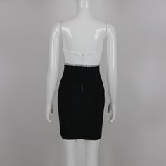 a mannequin wearing a black and white dress