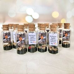 six small bottles filled with coins on top of a table