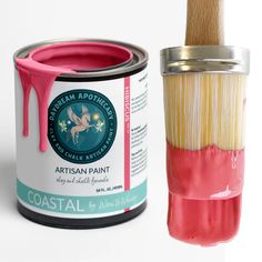 a paint can and brush are next to each other