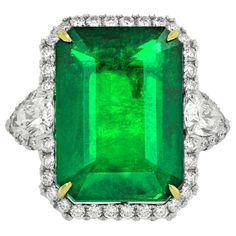 One GIA Certified Green Emerald and Diamond Ring, features 21.10 Carat Green Natural Emerald (GIA#2155900531), elongated emerald cut shape, certified by GIA Laboratory. Set with 3.40 Carats of diamonds, including two pear shaped diamonds on each side. Platinum Radiant Cut Diamond Ring, Emerald Cut Diamond Ring, Emerald And Diamond Ring, Platinum Diamond Rings, Emerald Diamond Ring, Fine Diamond Jewelry, Jewelry Rings Diamond, White Gold Diamond Rings, Buying Diamonds