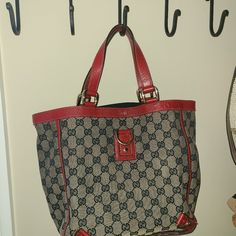 This Is An Authentic Gucci Medium Monogram Abbey D Ring Tote In Navy And Red. This Handbag Is Crafted With Classic Gucci Gg Monogram Canvas With Red Leather Handles And Trim Along With Gold Hardware. Interior Is Navy Fabric With Zippered Pocket. Great Condition, One Small Spot Pictured. Gucci Blue Tote Bag, Red Tote Bag, Gg Monogram, Red Tote, Navy Fabric, Leather Handles, D Ring, Monogram Canvas, Leather Handle