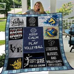 a woman is holding up a volleyball quilt