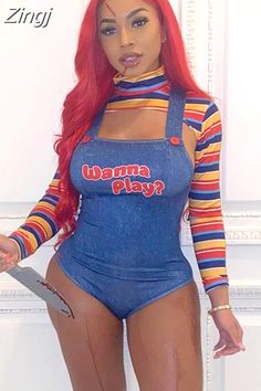 a woman with long red hair wearing a blue bodysuit and holding a knife in her mouth