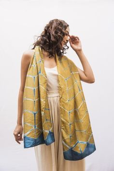 "Mustard Yellow Clamp Dye Shibori Silk Scarf, Geometric Print Shibori Statement Scarf, Perfect Scarf For Special Occasion, Scarf Gift For Her What is this item? A beautiful Shibori silk scarf with  a striking geometric design, handmade in the art of clamp dye Itajime Shibori tie dye. This piece is the perfect scarf gift for women who love luxury gifts, statement scarves and textiles. Hand-crafted from pure habutai silk. Clamp-dyed, this unique print features a striking design in a pretty shade of mustard yellow with graphic blue highlights. The high quality fabric has a beautiful fluidity and drape, is feather-light and finished with finely rolled hand-stitched edges. The versatile rectangular shape means it can be styled to suit formal looks or to elevate weekend casuals or celebrations. Itajime Shibori, Shibori Scarf, Hand Dyed Silk Scarf, Statement Scarf, Shibori Silk, Shibori Tie Dye, Blue Highlights, Best Mothers Day Gifts, Scarf For Women