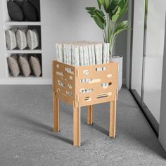 a chair made out of strips of wood with a potted plant in the background