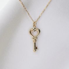 14K gold heart key necklace 14K gold heart key charm is about 18mm x 8.5mm 14K gold 1 mm diamond-cut cable chain All components are 14k gold Elegant Heart-shaped Key Jewelry, Elegant Heart-shaped Necklace With Two Keys, Classic Jewelry With Keys For Gifts, Elegant Two Keys Necklace As Gift, Elegant Two Keys Necklace Gift, Elegant Two Keys Necklace For Gift, Luxury Gold Jewelry With Keys, Gold Heart Necklace With Two Keys, Yellow Gold Key Pendant Jewelry