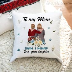 a personalized pillow with two women hugging each other on a white carpeted area