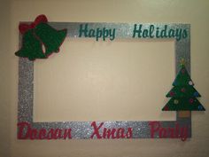 a holiday photo frame with christmas trees and bells on the front, happy holidays written in green